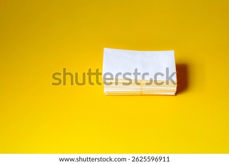 A stack of clean, white dry tissues arranged neatly on a surface. Soft texture and hygienic appearance, ideal for personal care, hygiene, or household use. Minimalist background emphasizes cleanlines