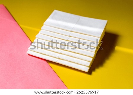 A stack of clean, white dry tissues arranged neatly on a surface. Soft texture and hygienic appearance, ideal for personal care, hygiene, or household use. Minimalist background emphasizes cleanlines