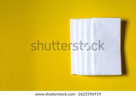A stack of clean, white dry tissues arranged neatly on a surface. Soft texture and hygienic appearance, ideal for personal care, hygiene, or household use. Minimalist background emphasizes cleanlines