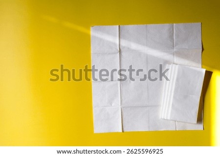 A stack of clean, white dry tissues arranged neatly on a surface. Soft texture and hygienic appearance, ideal for personal care, hygiene, or household use. Minimalist background emphasizes cleanlines