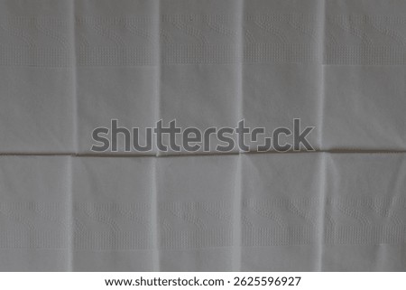 A stack of clean, white dry tissues arranged neatly on a surface. Soft texture and hygienic appearance, ideal for personal care, hygiene, or household use. Minimalist background emphasizes cleanlines