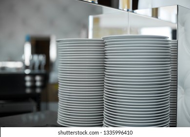 stack of clean white plates in a restaurant. Event prepare details.