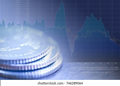 Stack of coin close-up in blue-green tone with graph and fictitious text in background