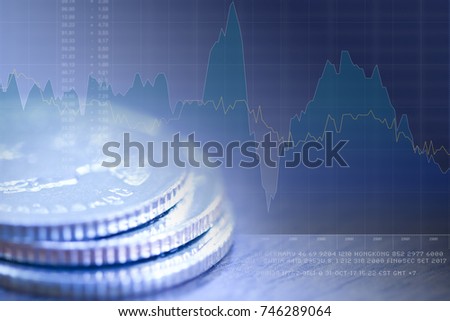Stack of coin close-up in blue-green tone with graph and fictitious text in background