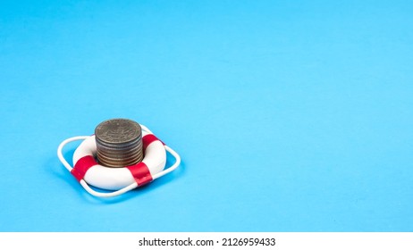 Stack coin in lifebuoy.
				Concept security of money, guaranteed deposits. Client rights protection. Compensation for losses in inflation, safeguarded investment capital.
