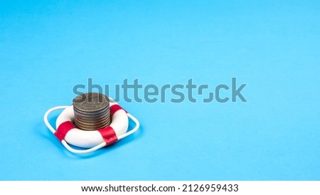 Stack coin in lifebuoy.
Concept security of money, guaranteed deposits. Client rights protection. Compensation for losses in inflation, safeguarded investment capital.
