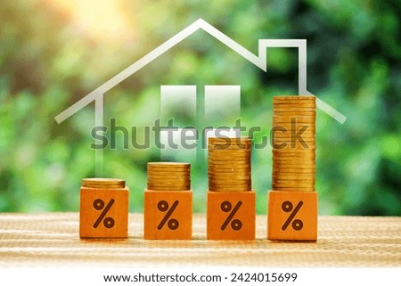 Stack of coins, arrangement of wooden blocks with percentages. concept of Increase in interest rates, home loan, mortgage, house tax. investment and asset management concept