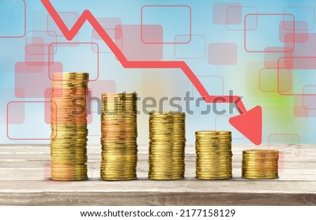 Stack of coins bar chart and graph trending downwards. Economy recession crisis, inflation, stagflation, business and financial loss concept.