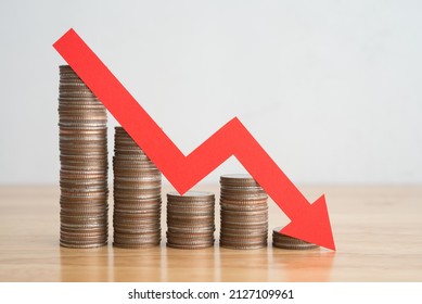Stack of coins bar chart and red graph trending downwards with white wall background on wooden table copy space. Economy recession crisis, inflation, stagflation, business and financial loss concept. - Shutterstock ID 2127109961