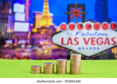 Stack of coins with blur Las vegas sign on background