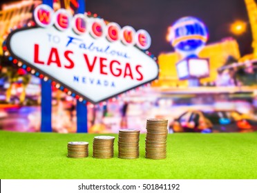 Stack of coins with blur Las vegas sign on background