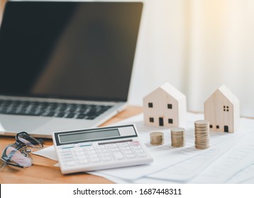 Stack Of Coins With Calculator,House Model,tax Form,glasses And Tablet,Income Tax Raise Concept.
