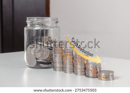 Stack of coins in descending order with down arrow and a glass jar filled with coins. Cost reduction concept.