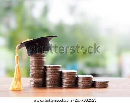 Stack of coins with graduation hat. The concept of saving money for education, student loan, scholarship, tuition fees in the future