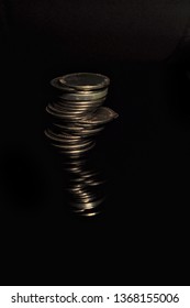 stack of coins isolated on black background. mirror reflection