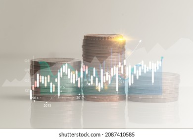 Stack of coins isolated from white background with graph lines reporting corporate earnings growth derived from valuation in economic investments.