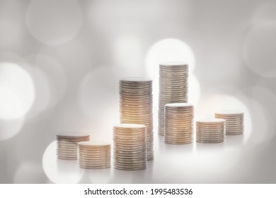 Stack Of Coins On Abstract Background. Saving With Return On Investment Concept And Sustainable Economic Growth Idea