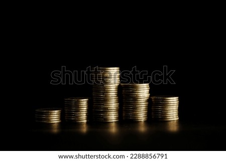 Stack of coins on black background, Saving money concept