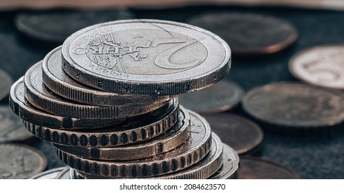 Stack of coins on grey textured background. - Shutterstock ID 2084623570
