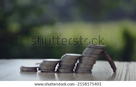 stack of coins on stairs leaning on crutches blur background concept risk loss economic downturn
