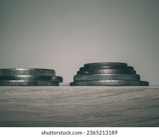 stack of coins on a wooden table - Shutterstock ID 2365213189