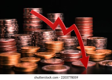 Stack coins and red arrows down.  trending downwards. Economy recession crisis, inflation, stagflation, business and financial loss concept.                       - Powered by Shutterstock - Get 15% off with code: PIKWIZARD15