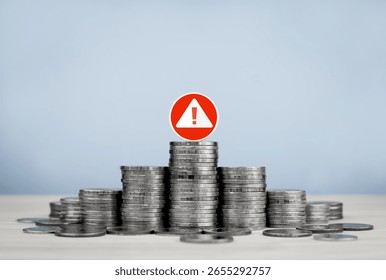 Stack of coins and red circle warning sign, with copy space. Concept of financial risk management, financial urgency, investment analysis and decision making.