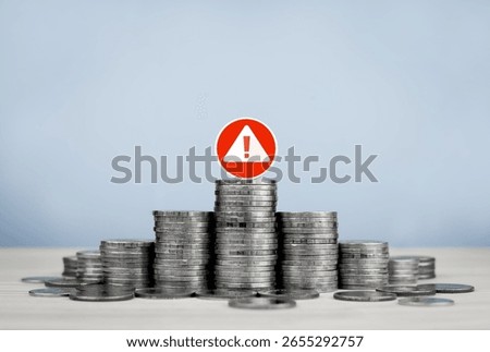 Stack of coins and red circle warning sign, with copy space. Concept of financial risk management, financial urgency, investment analysis and decision making.
