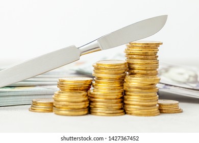 Stack of coins and a scalpel. The concept of expensive surgeon services or medical insurance. Gray background with money - Powered by Shutterstock