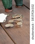 stack of coins stacked on the table bet on the background of glasses