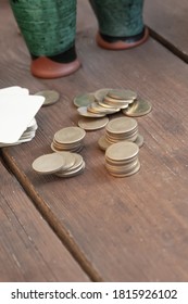 stack of coins stacked on the table bet on the background of glasses