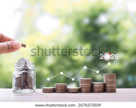 Stack of coins with virtual increasing graph. The concept of saving money for business growth, Financial investment, Market stock, Profit return, Dividend and Business fund in year 2026.