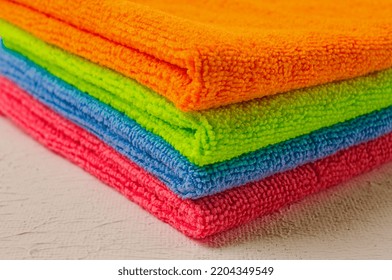 A Stack Of Colored Cloth , Microfiber, For Cleaning The House, On A White Table, Horizontal, No People,