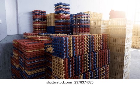 Stack of colored plastic trays for hatching eggs.