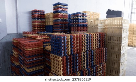 Stack of colored plastic trays for hatching eggs.