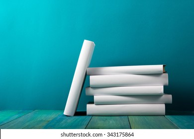 Stack Of Colorful Books, Grungy Blue Background, Free Copy Space Vintage Old Hardback Books On Wooden Shelf On The Deck Table, No Labels, Blank Spine. Back To School. Education Background