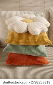 Stack of colorful pillows on soft sofa indoors, closeup