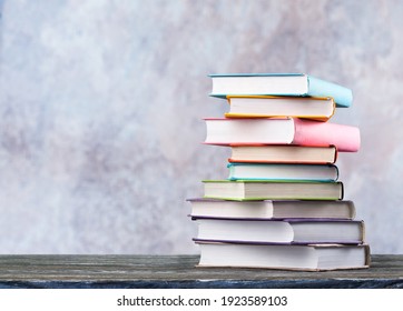 Stack Of Colorful School Books On Wooden Desk