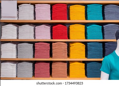 Stack Of Colorful Shirt On Shelf Store