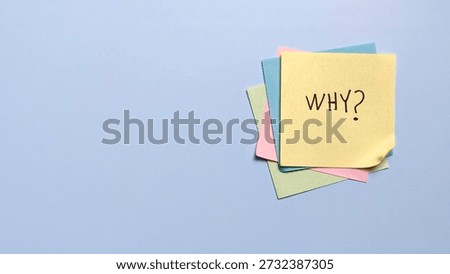 Stack of colorful sticky notes with handwritten why text for brainstorming and creative problem solving