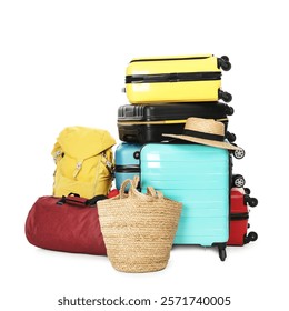 Stack of colorful suitcases, backpack, beach bag and straw hat isolated on white