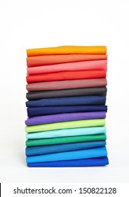 Stack of colorful t-shirts on the white background