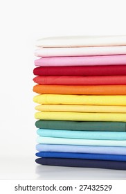 Stack Of Coloured Linens On White Background