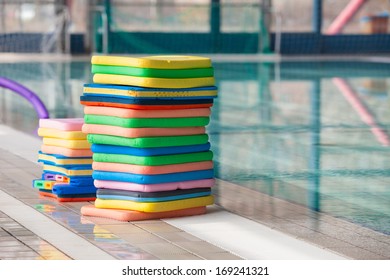 Stack of the colourful swim boards in the swimming pool.