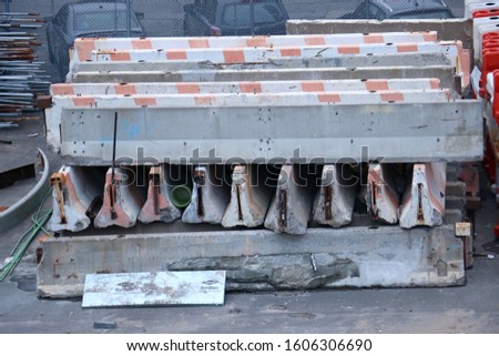A stack of concrete jersey barriers at a construction site in New York City, New York