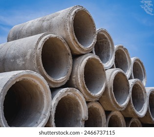 A stack of concrete ring pipes piled and creating a symmetrical arrangement