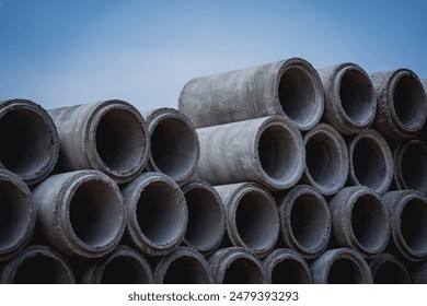 A stack of concrete ring pipes piled and creating a symmetrical arrangement