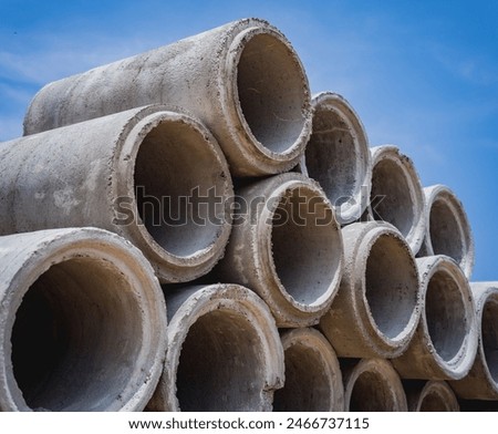 A stack of concrete ring pipes piled and creating a symmetrical arrangement