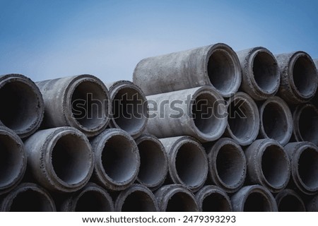 A stack of concrete ring pipes piled and creating a symmetrical arrangement
