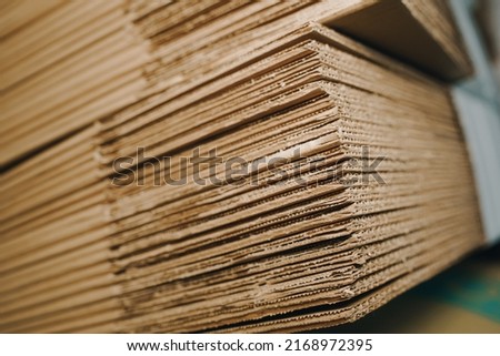 stack of containerboard sheets in warehouse facility